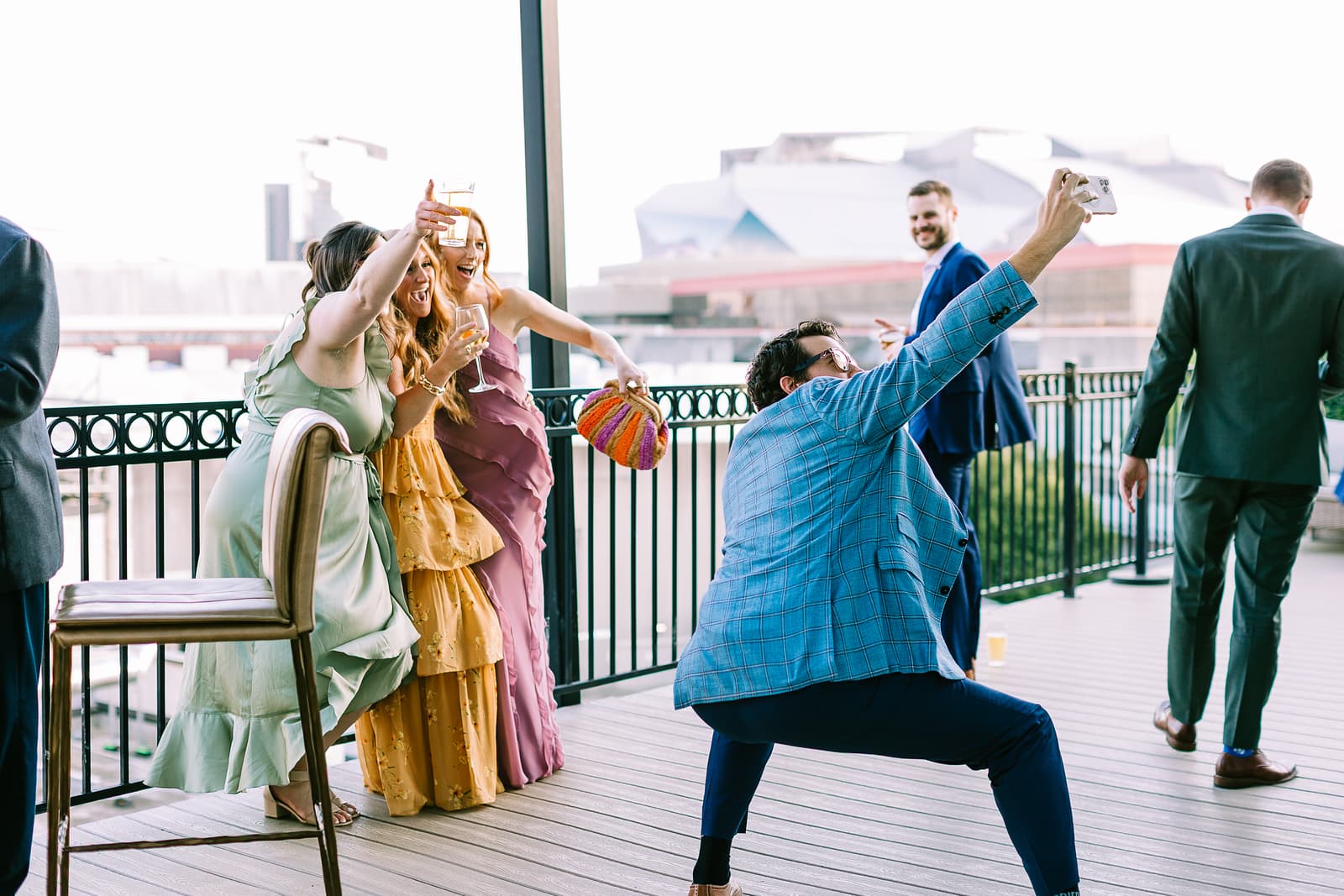 Wedding guests taking a selfie with Mercedes-Benz Stadium behind them