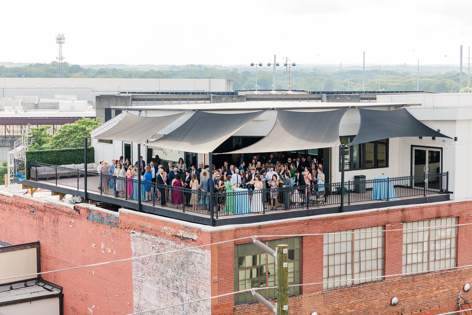 Aerial view of guests filling the shaded Rooftop Terrace at Terminus 330