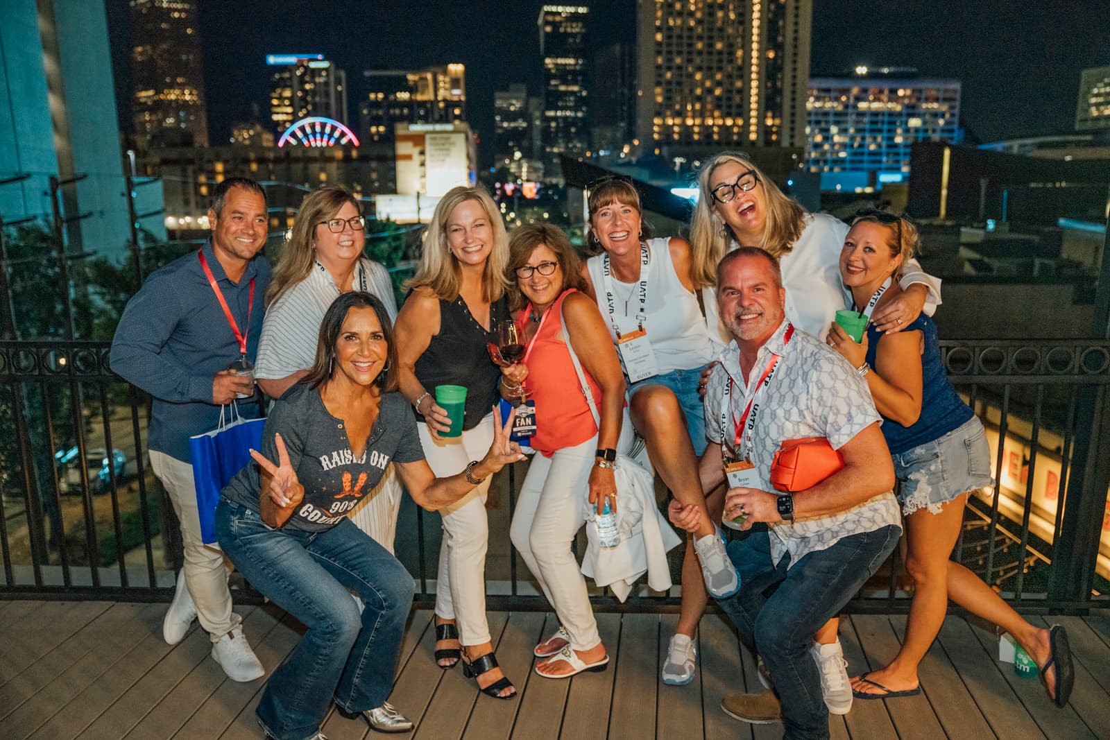 Group posing at night against the lit downtown Atlanta skyline