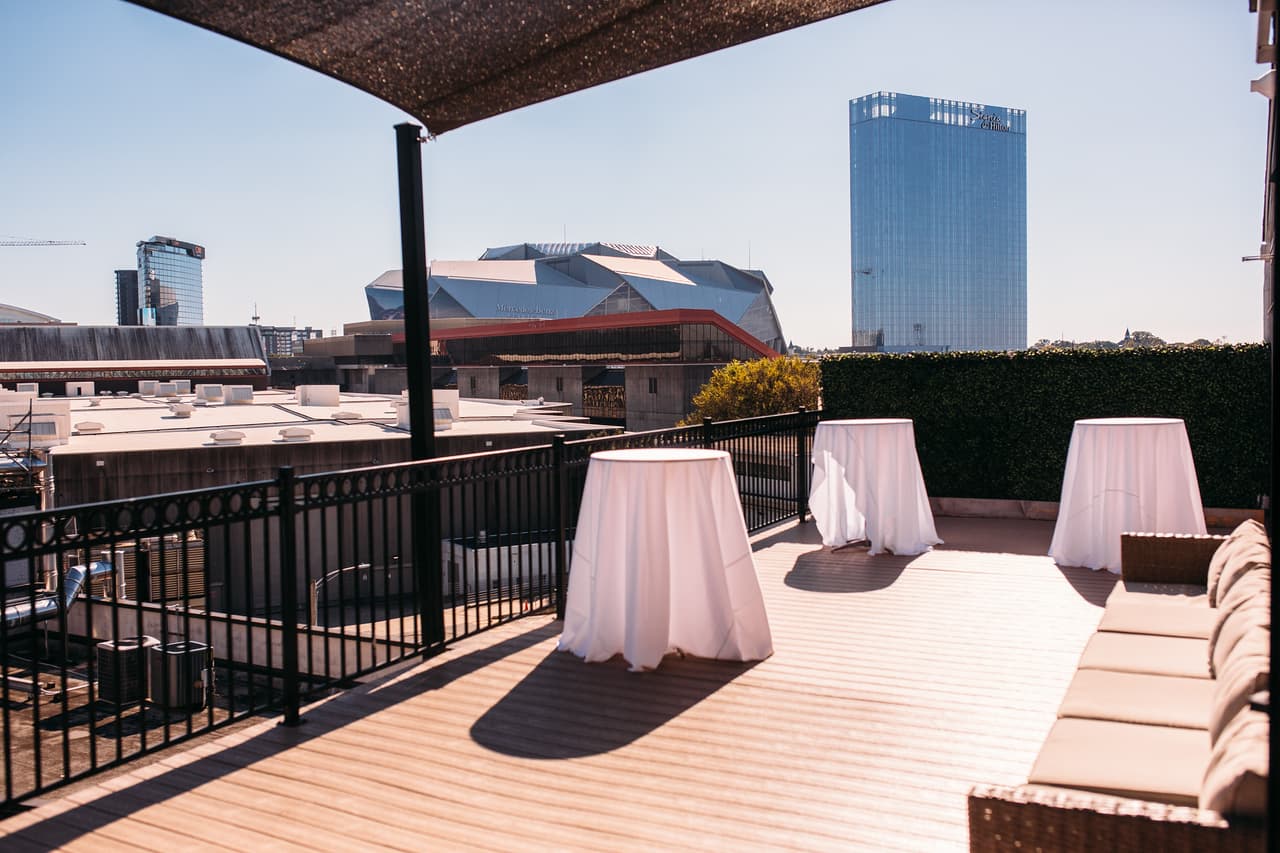 Rooftop cocktail tables overlooking Mercedes-Benz Stadium in downtown Atlanta