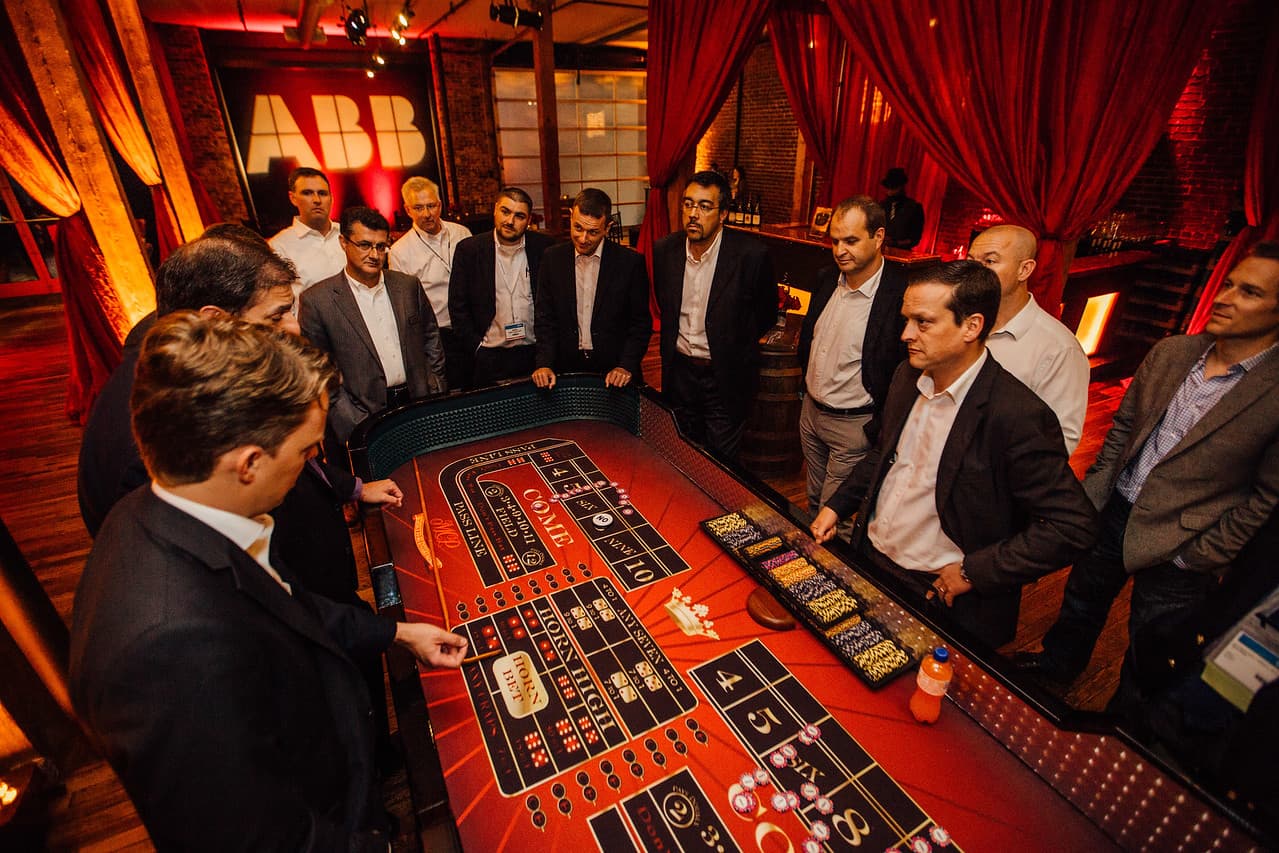 Casino-night craps table with attendees at a corporate event