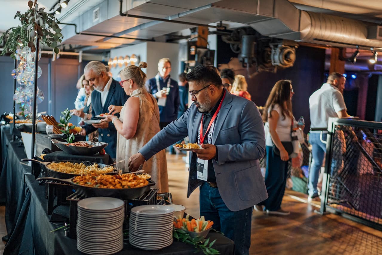 Conference attendees serving themselves from a cast-iron skillet buffet