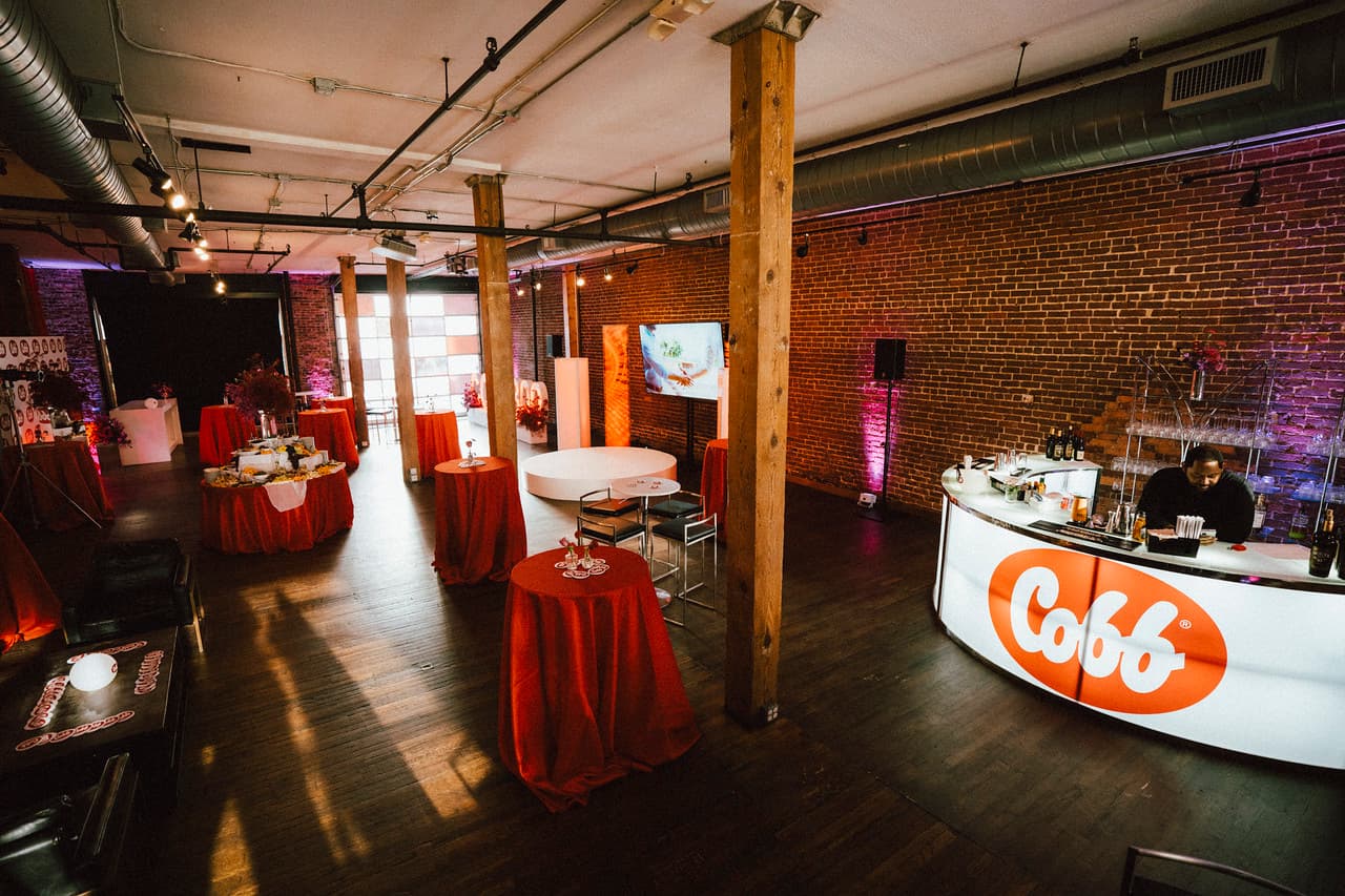 Branded glowing bar and red cocktail tables at Terminus 330