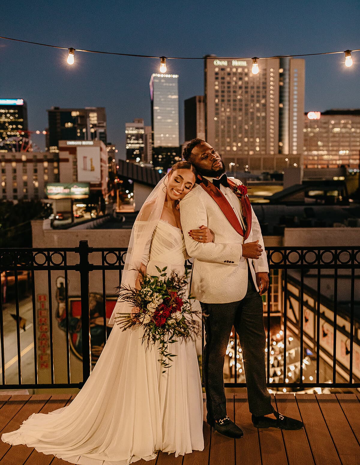 Couple on rooftop with head on shoulder