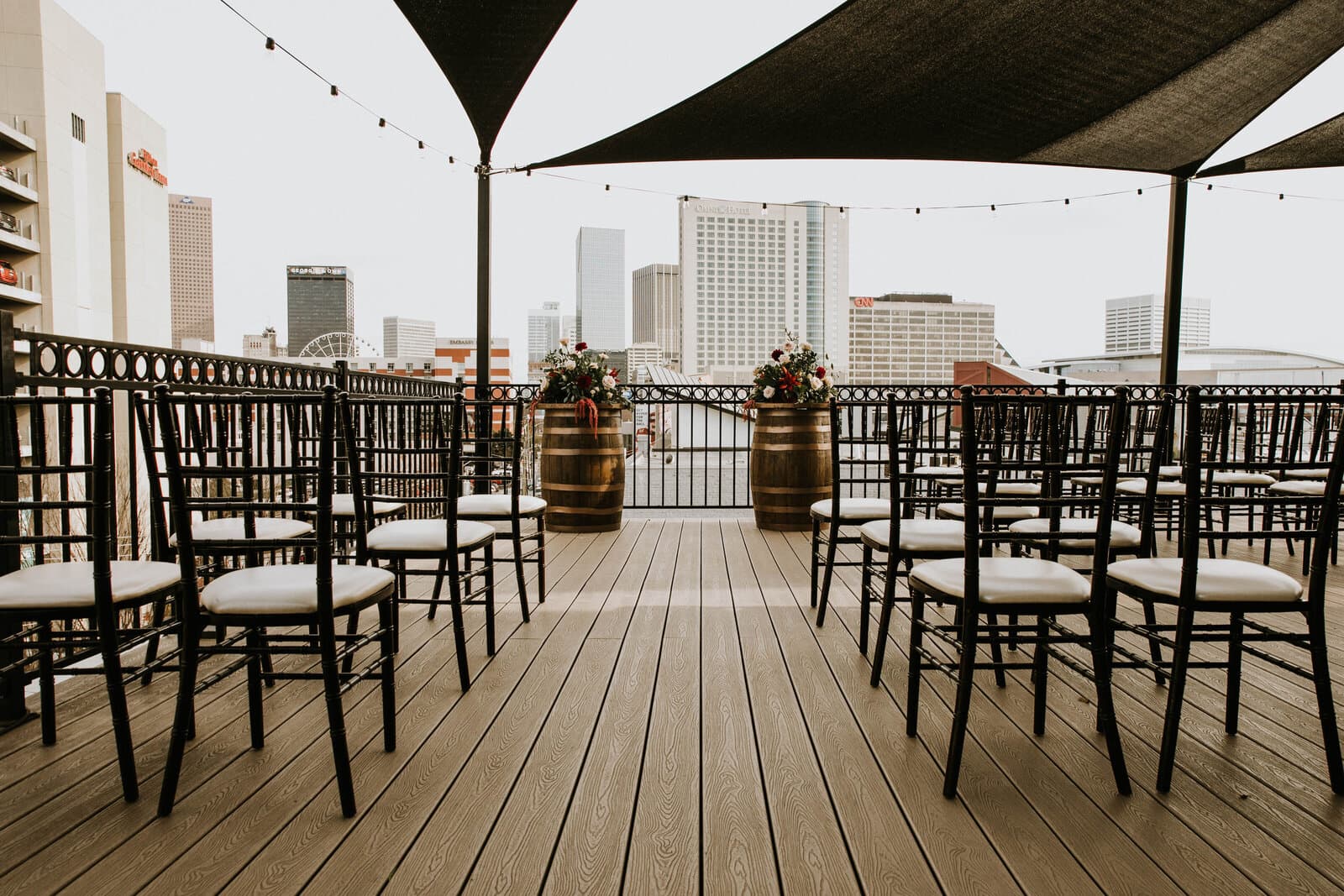 Rooftop ceremony setup with aisle and whiskey barrels